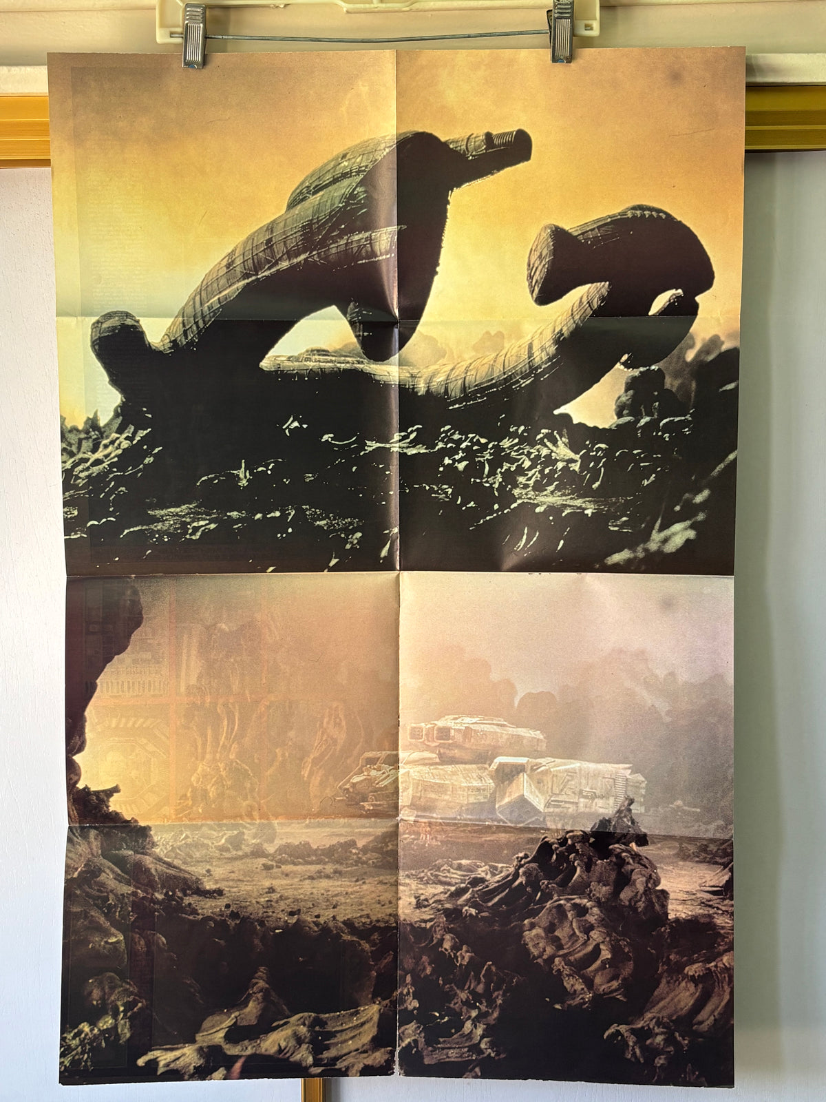 A vintage four-panel sci-fi poster print depicting a massive stone serpent-like creature in a desert landscape under a golden sky, hanging on a wall with clips.
33in tall
